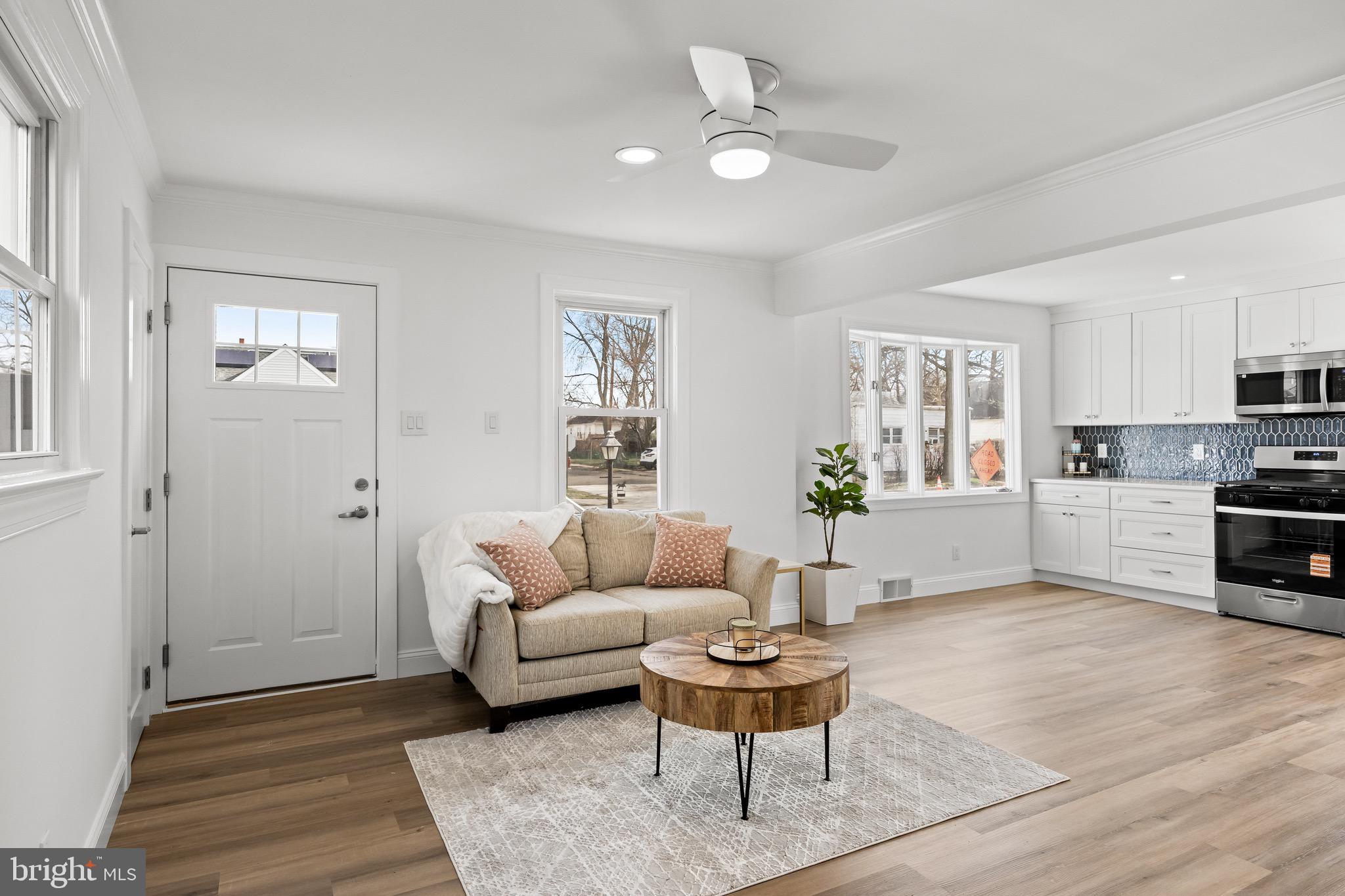 42 Spruce Avenue Maple Shade, NJ 08052 - Photo 7 of 27 a living room with furniture and a dining table with wooden floor