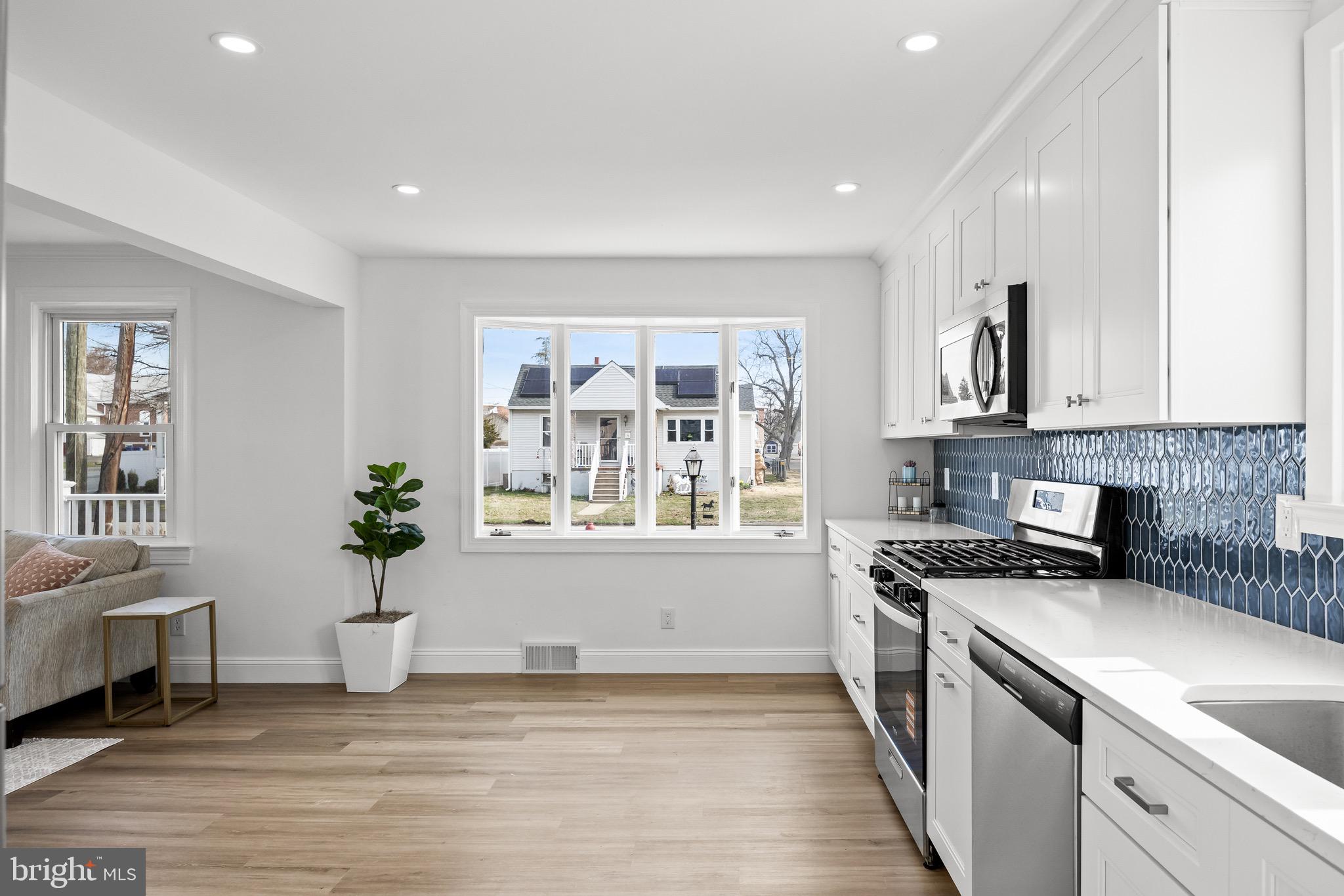 42 Spruce Avenue Maple Shade, NJ 08052 - Photo 10 of 27 a kitchen that has a sink and a stove top oven