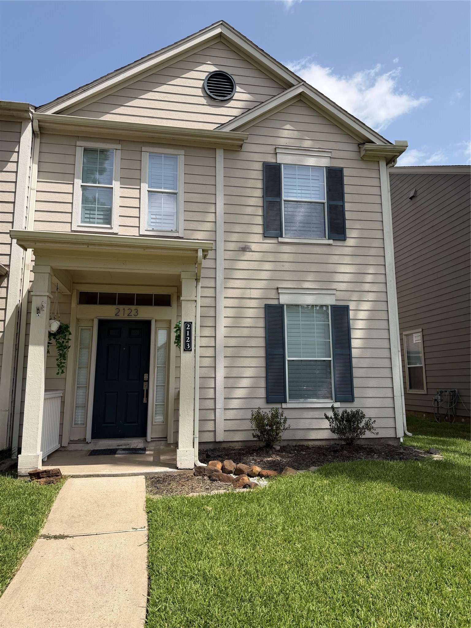 2123 Rustling Trees Way Spring, TX 77373 - Photo 2 of 21 Charming two-story townhouse with a welcoming front entrance, well-maintained lawn, and classic siding. Features include a covered porch and double-pane windows for ample natural light.