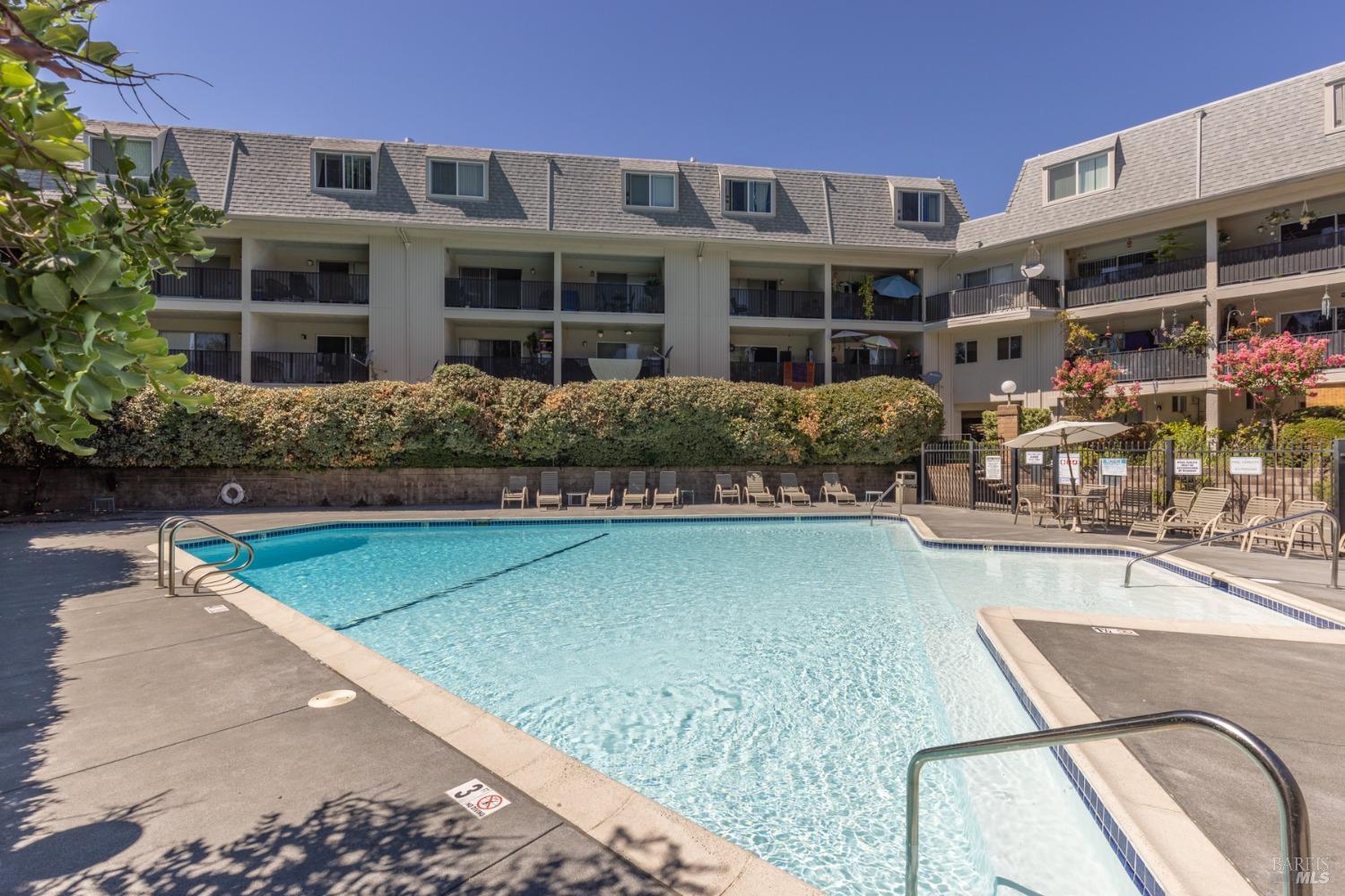 a view of a patio with chairs and plants