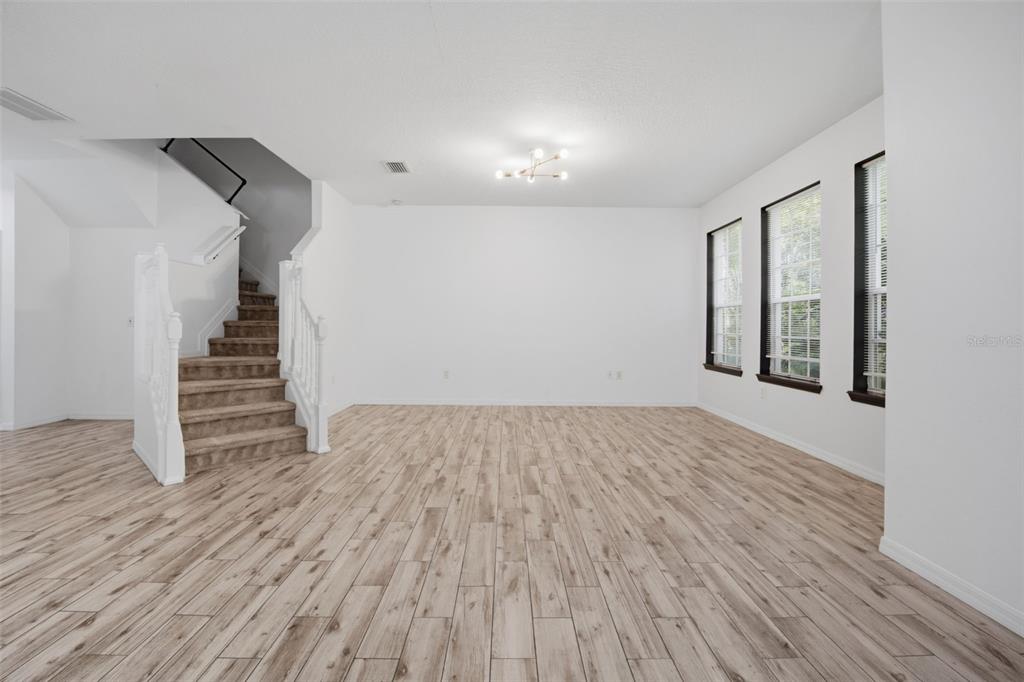 27547 Pleasure Ride Loop Wesley Chapel, FL 33544 - Photo 11 of 40 wooden floor in an empty room with a window