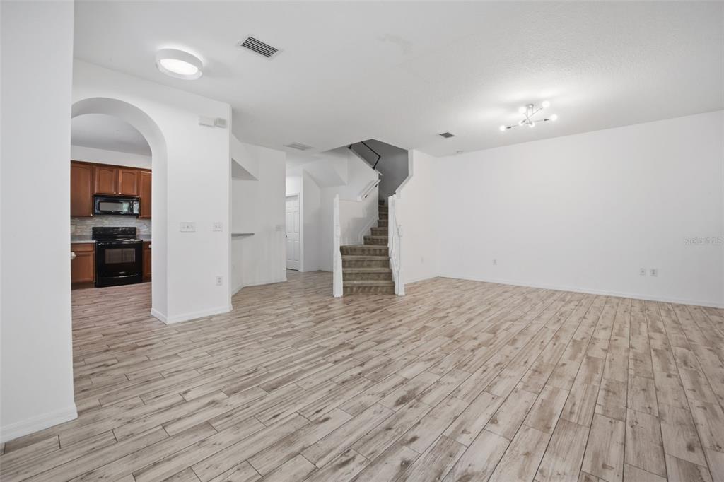 27547 Pleasure Ride Loop Wesley Chapel, FL 33544 - Photo 14 of 40 a view of empty room with wooden floor