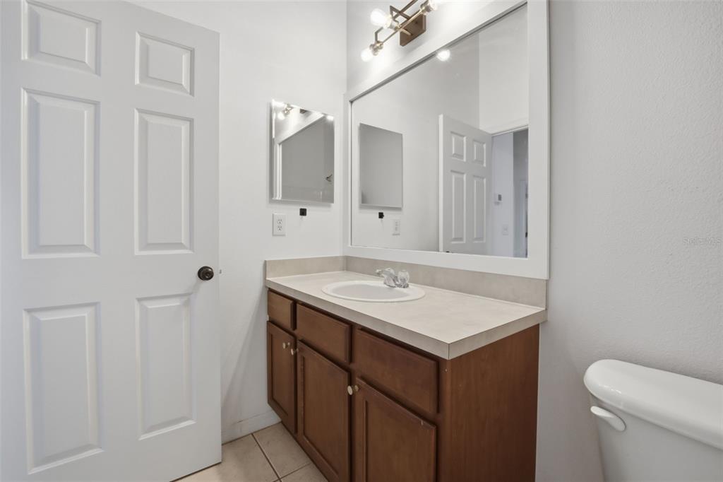 27547 Pleasure Ride Loop Wesley Chapel, FL 33544 - Photo 27 of 40 a bathroom with a sink vanity and a mirror