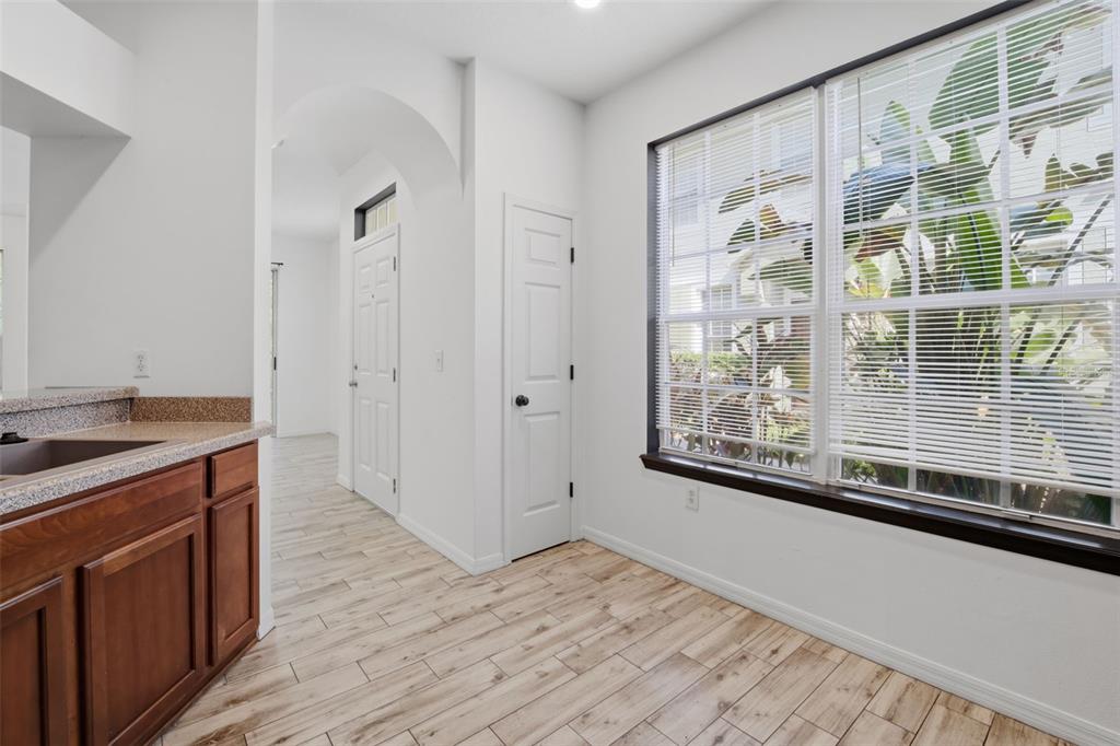 27547 Pleasure Ride Loop Wesley Chapel, FL 33544 - Photo 8 of 40 a view of a kitchen with wooden floor and a sink
