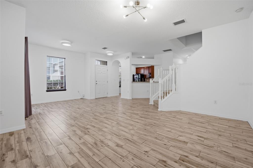 27547 Pleasure Ride Loop Wesley Chapel, FL 33544 - Photo 9 of 40 a view of empty room with wooden floor