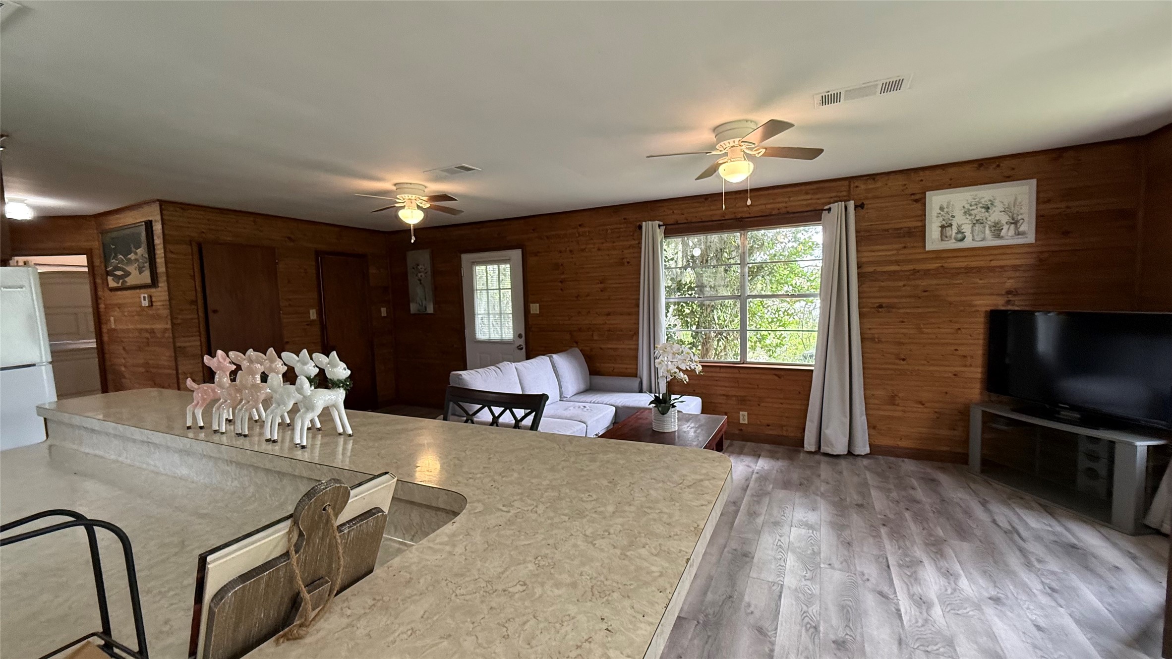 215 Weldon Livingston, TX 77351 - Photo 6 of 22 a living room with furniture a large window and a chandelier