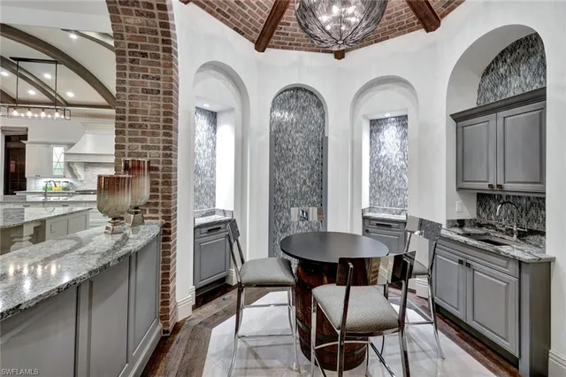 a spacious bedroom with a large bed and a flat tv screen on dresser