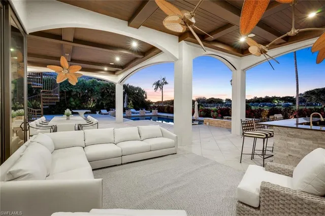 a view of a patio with couches chairs and a fire pit