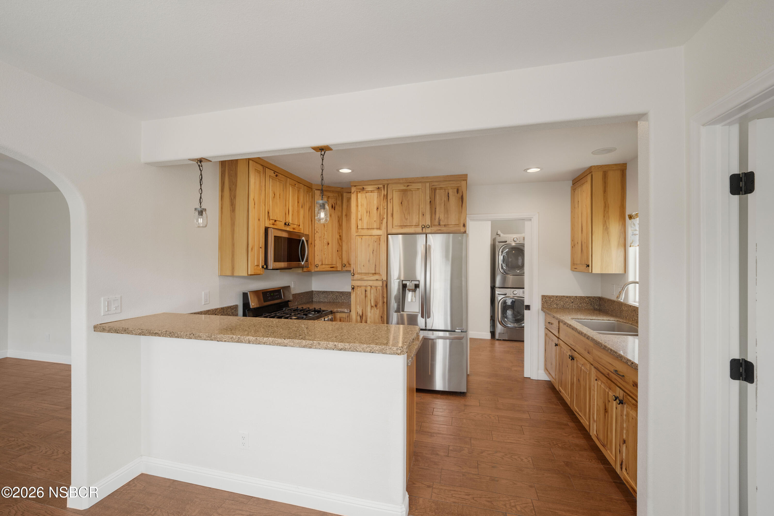 138 North E Street Lompoc, CA 93436 - Photo 11 of 35 a kitchen with granite countertop a refrigerator and a sink