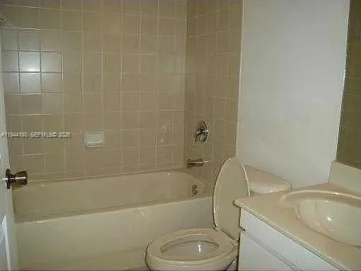 a bath room with a toilet and a bath tub