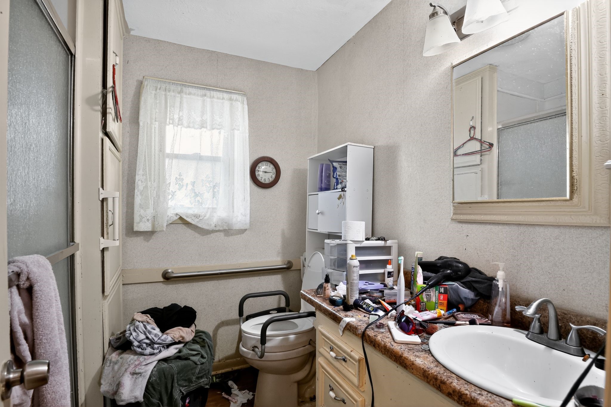 2319 Woodville Road Bryan, TX 77803 - Photo 12 of 15 a bathroom with a sink mirror and a toilet