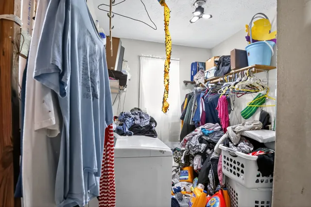 a view of walk in closet with clothes and shoes