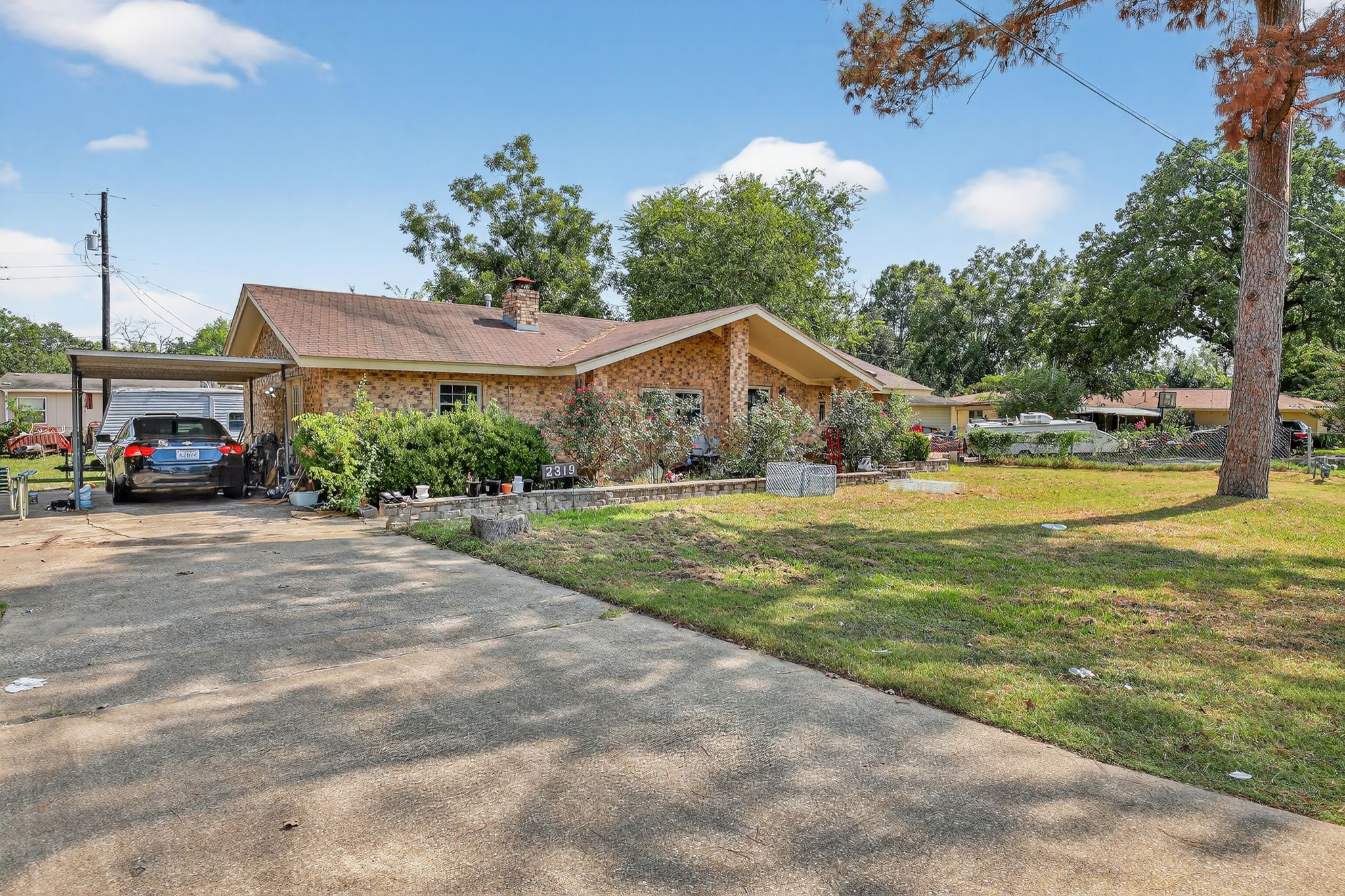 2319 Woodville Road Bryan, TX 77803 - Photo 2 of 15 a view of house with garden space and car parked