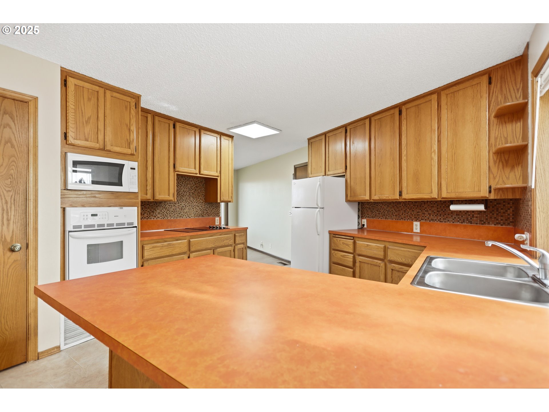 512 6th Street Wasco, OR 97065 - Photo 13 of 45 a kitchen with stainless steel appliances kitchen island granite countertop a refrigerator sink and cabinets