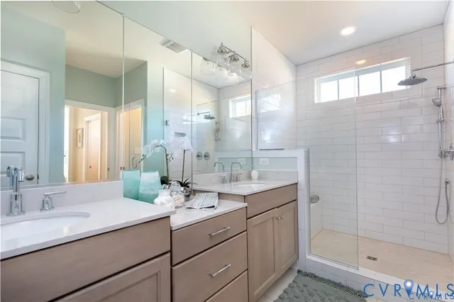 a bathroom with a granite countertop sink mirror and double