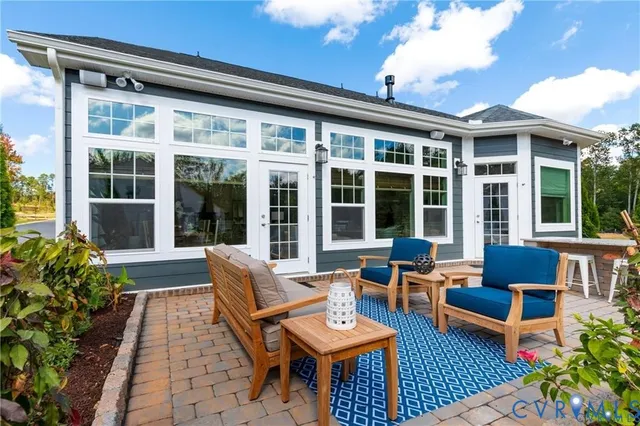 a view of a patio with couches table and chairs and potted plants