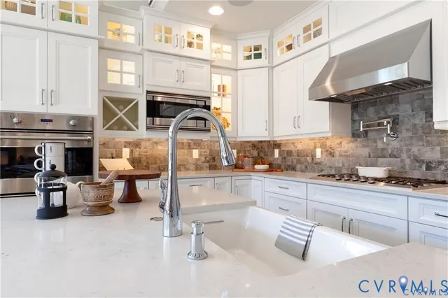 a kitchen with a sink appliances and cabinets