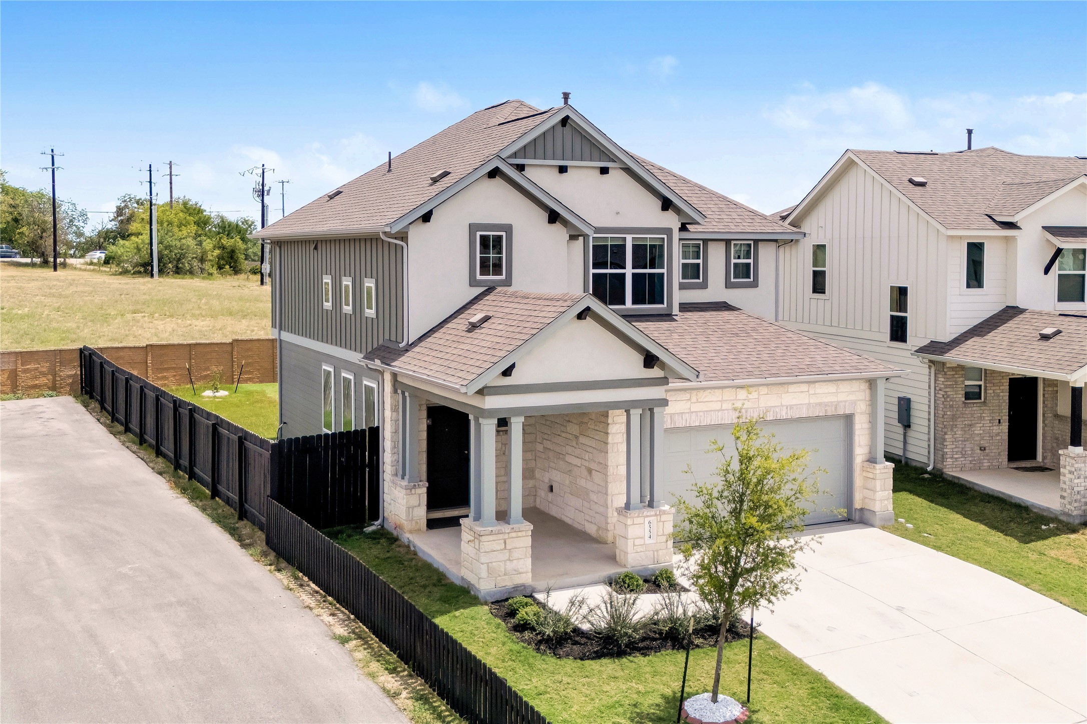 6554 Marsh Lane Buda, TX 78610 - Photo 1 of 30 a front view of a house with garden