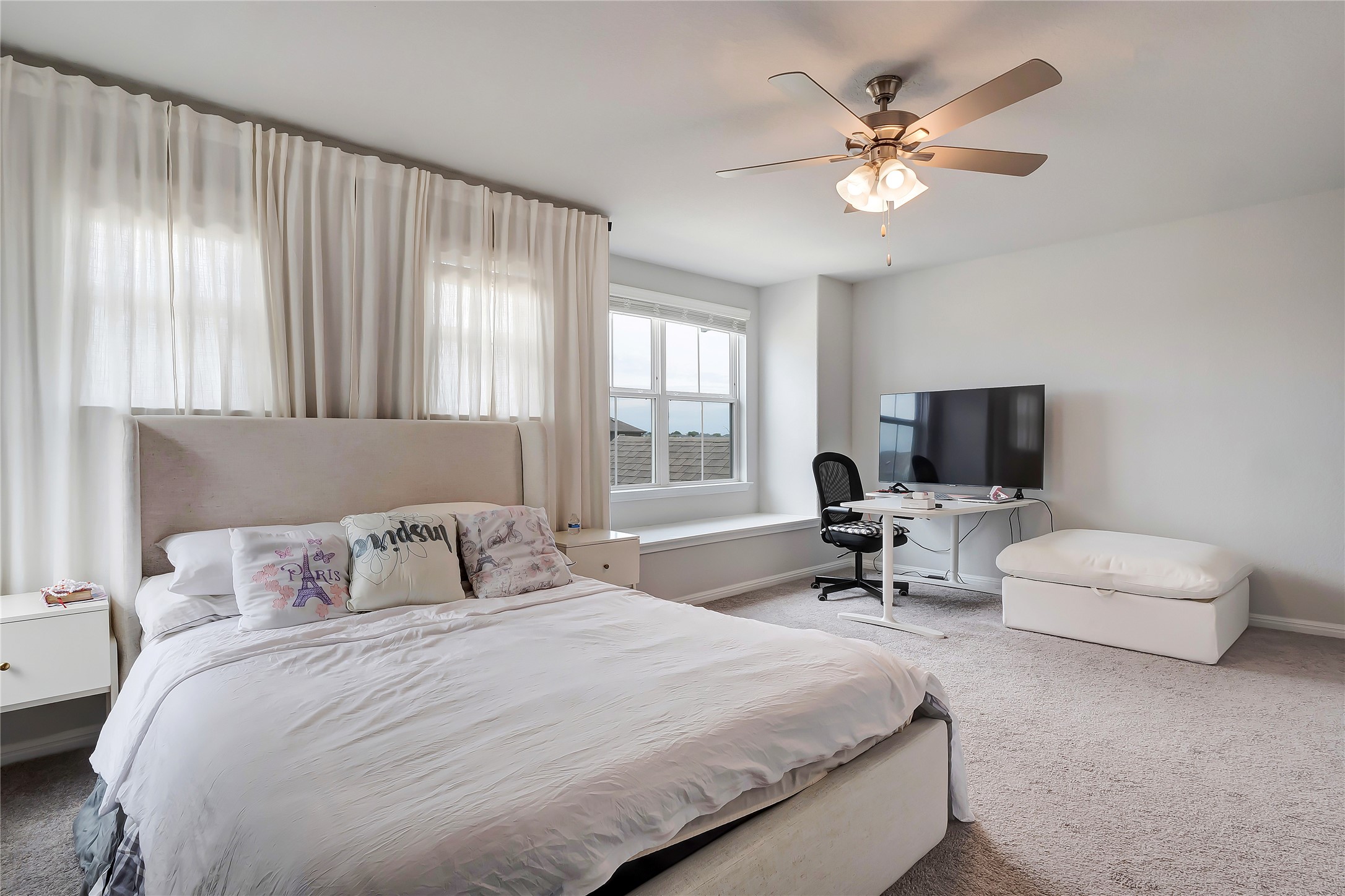 6554 Marsh Lane Buda, TX 78610 - Photo 12 of 30 a bedroom with a bed and a large window