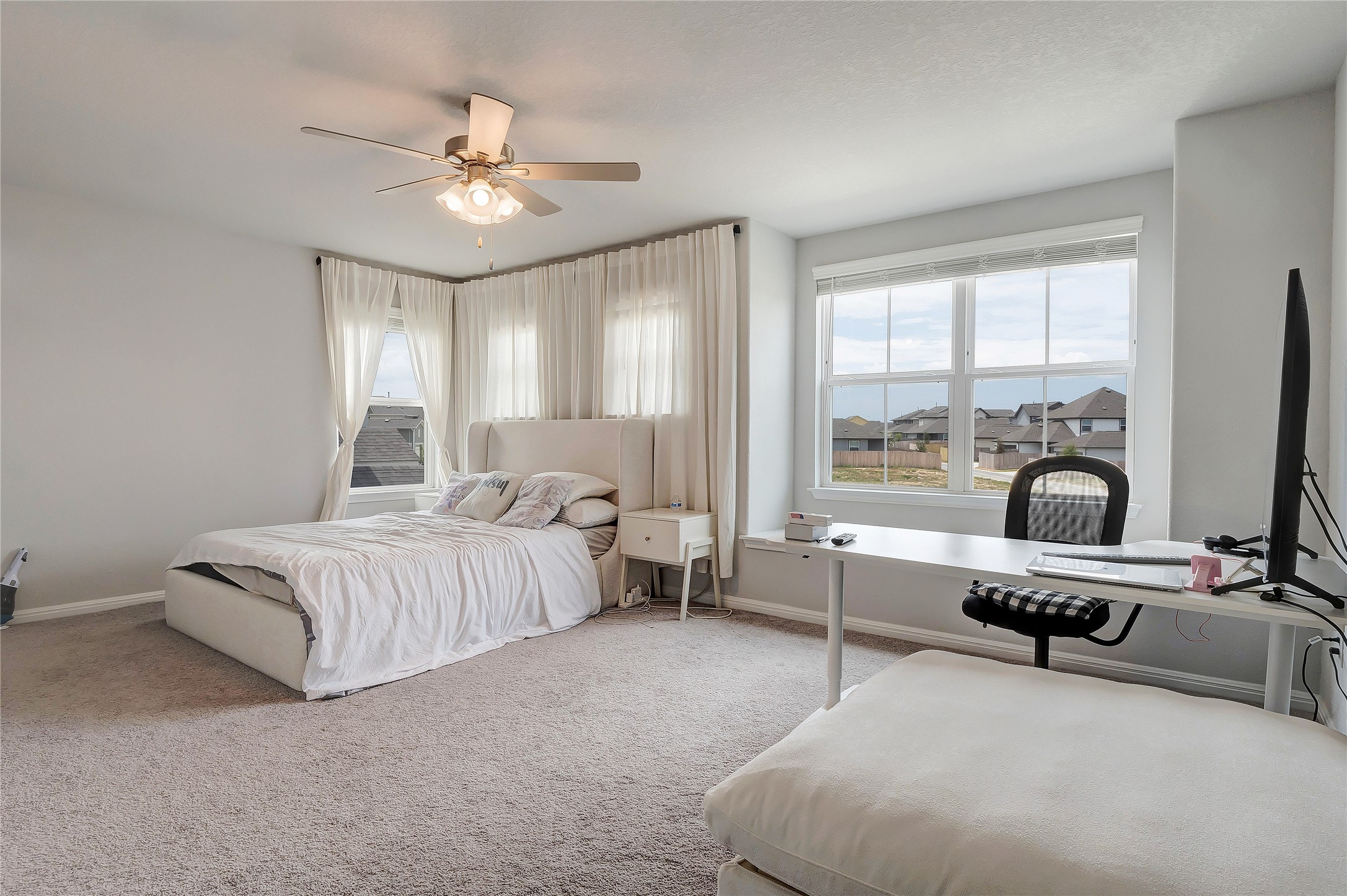 6554 Marsh Lane Buda, TX 78610 - Photo 13 of 30 a bedroom with bed and a large window