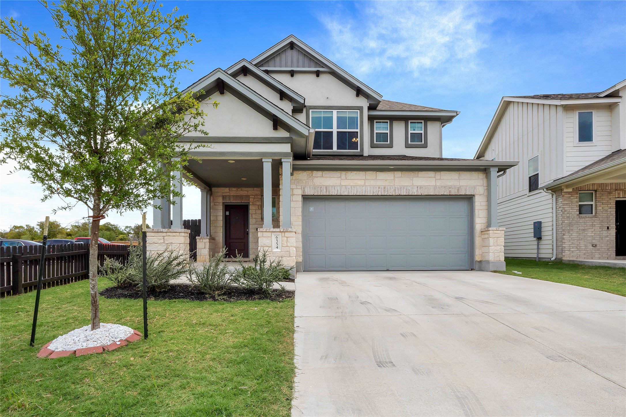 6554 Marsh Lane Buda, TX 78610 - Photo 22 of 30 a front view of a house with a yard and porch