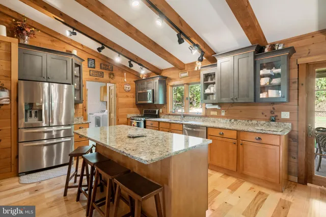 a kitchen with stainless steel appliances granite countertop a sink and cabinets