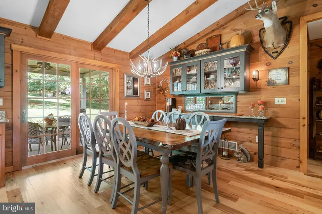 a bedroom with a bed and a large window with the outer view