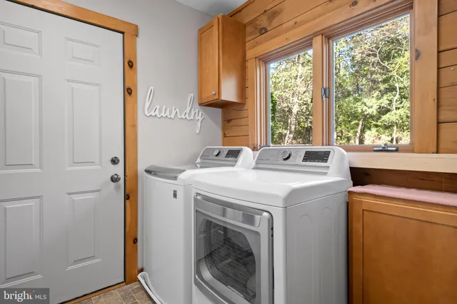 a view of a porch with furniture and a yard