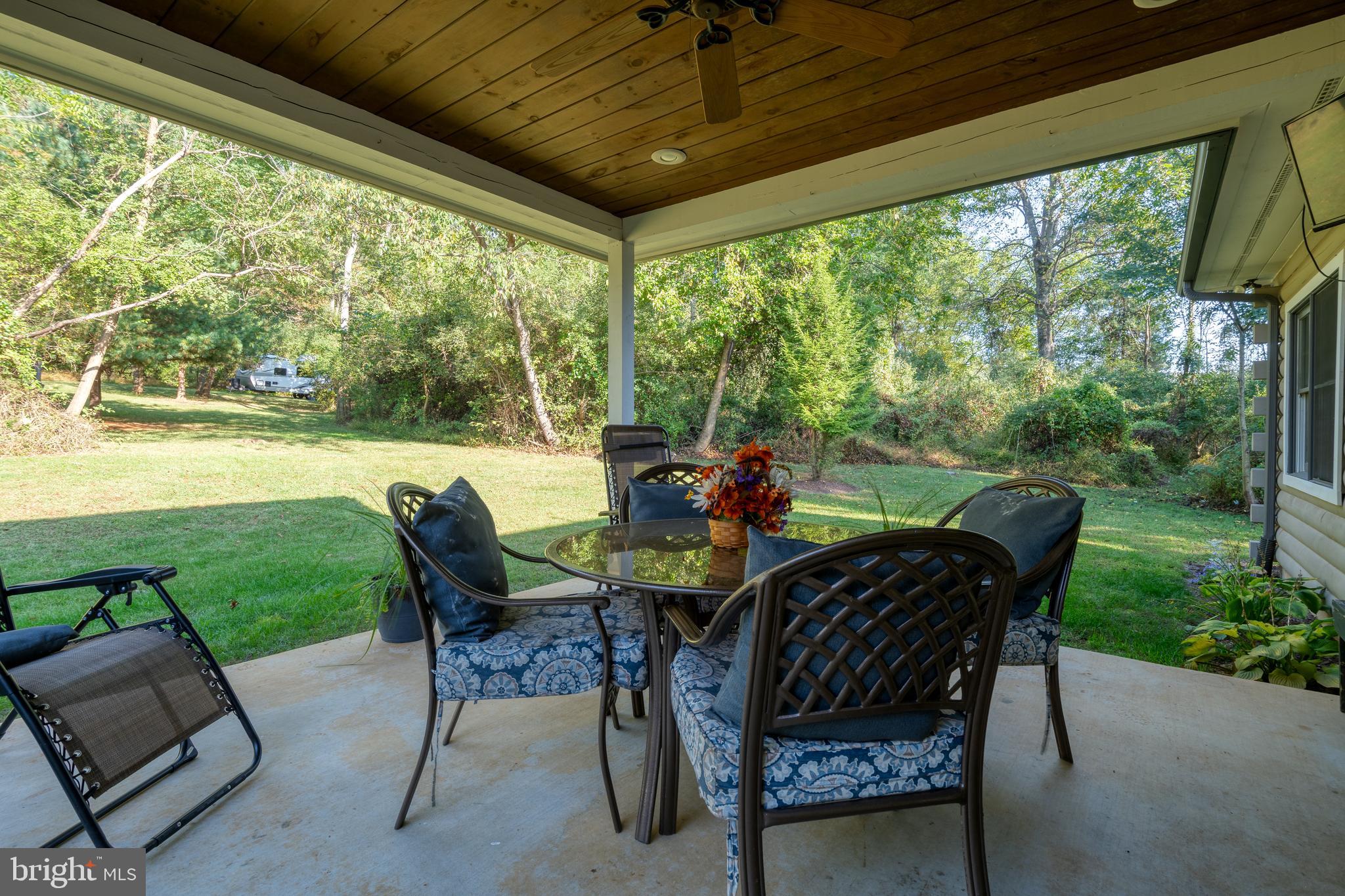 1967 Pinetown Road Wellsville, PA 17365 - Photo 31 of 58 a view of a patio with a table chairs and a backyard
