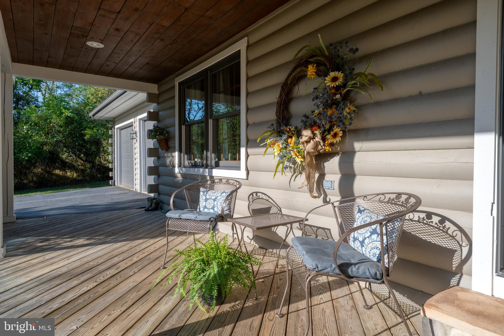 1967 Pinetown Road Wellsville, PA 17365 - Photo 41 of 58 a view of a patio with table and chairs and floor to ceiling window with wooden fence