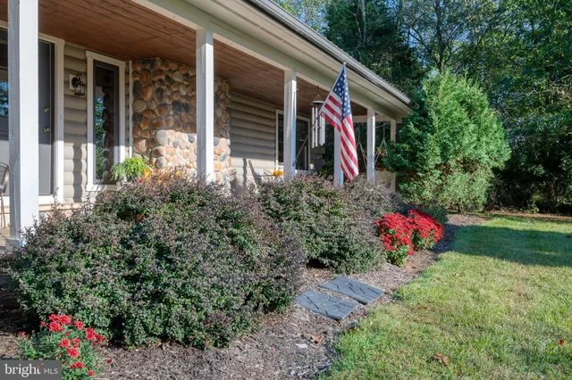 a backyard of a house with lots of green space and fountain