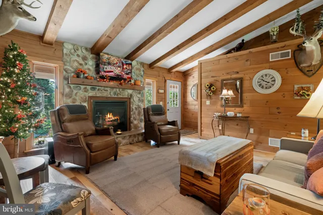 a kitchen with stainless steel appliances granite countertop table chairs and wooden floors