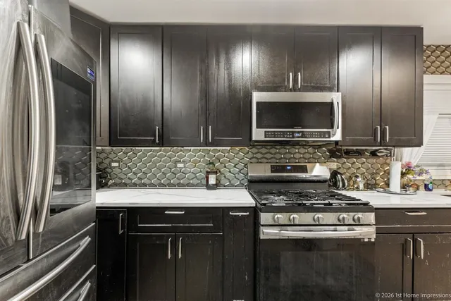 a kitchen with a sink stove and microwave
