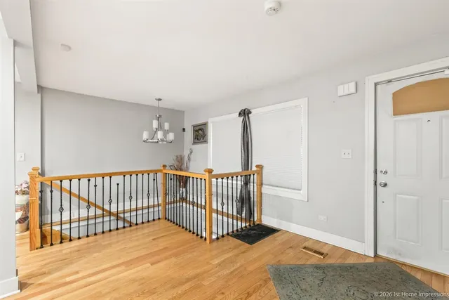 a view of a bedroom with wooden floor