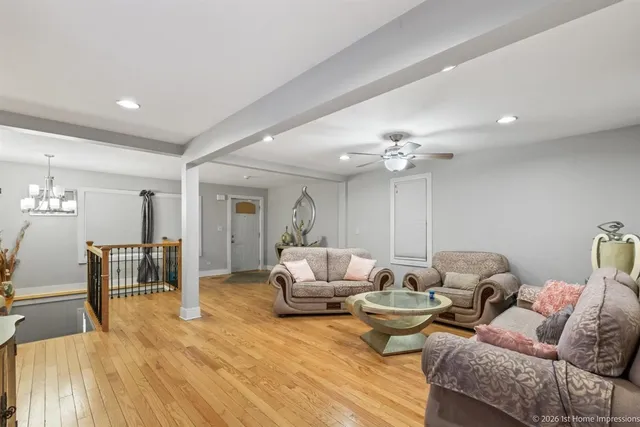 a living room with furniture and wooden floor