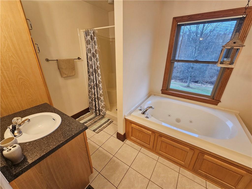 225 Profio Road McDonald, PA 15057 - Photo 23 of 49 a bathroom with a tub a sink and a shower