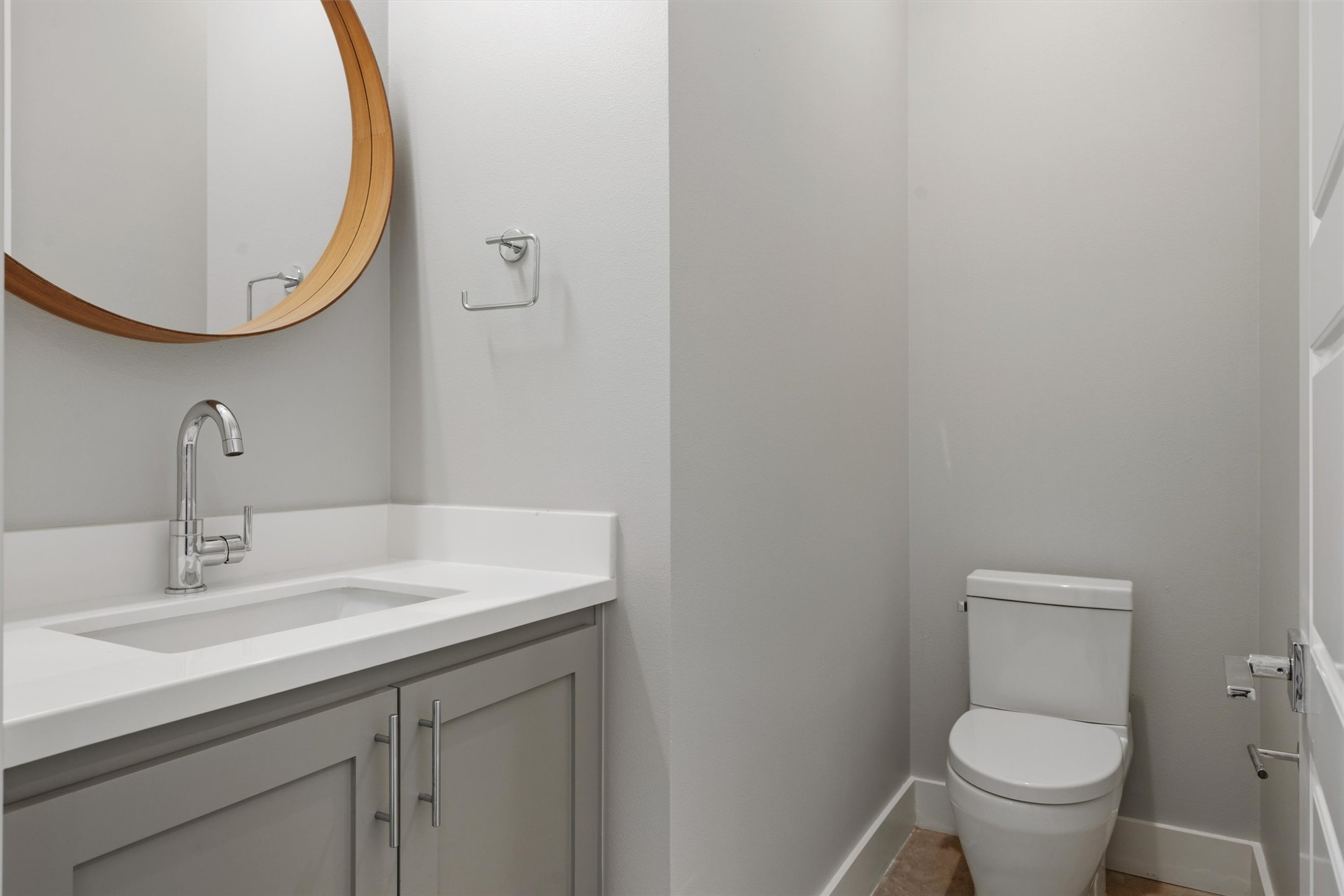 1210 Stobaugh Street, Unit B Austin, TX 78757 - Photo 26 of 40 A well-appointed powder room features a sleek vanity with an integrated sink and a modern toilet.