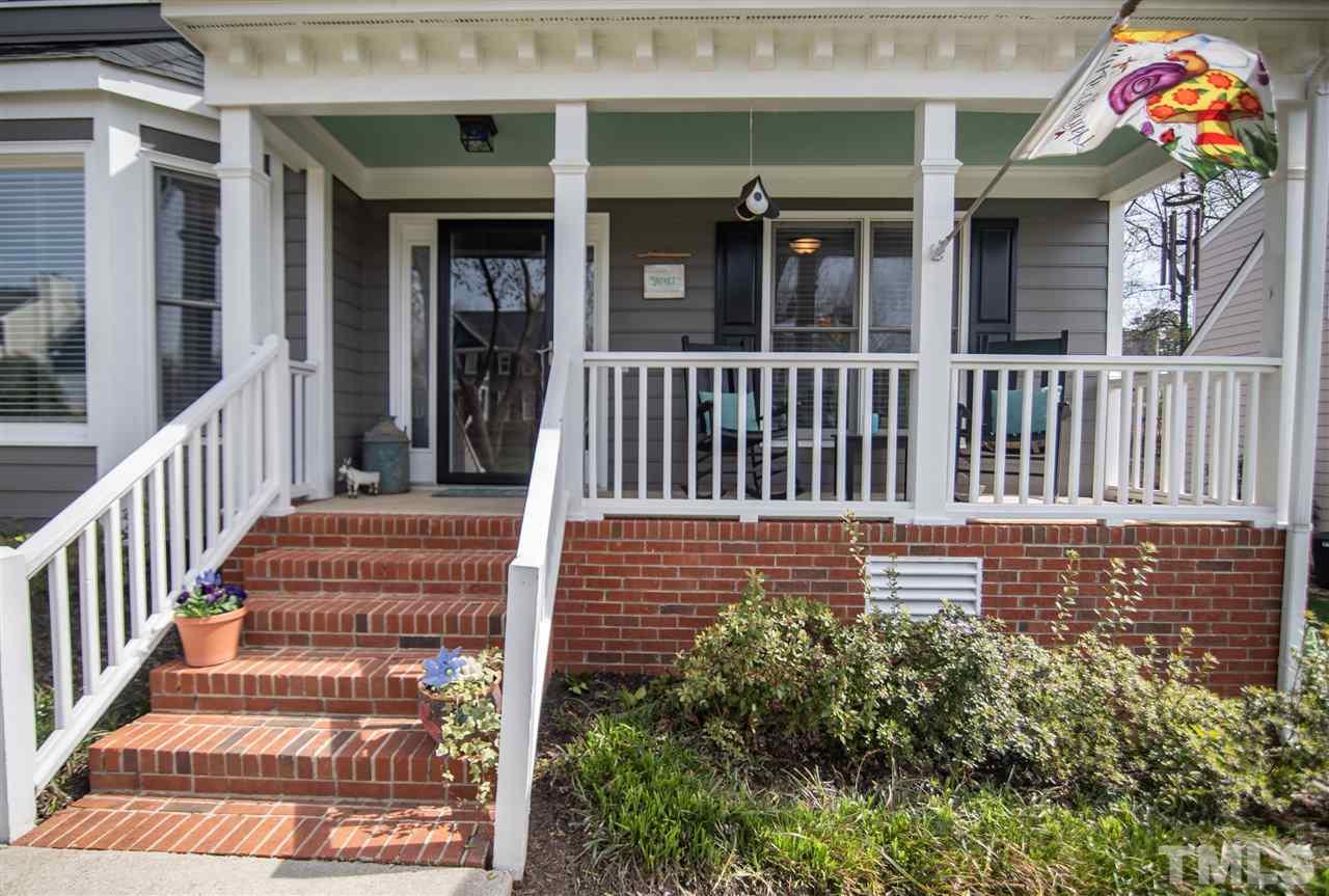 9116 Dawnshire Road Raleigh, NC 27615 - Photo 3 of 30 a view of a brick house with a bench