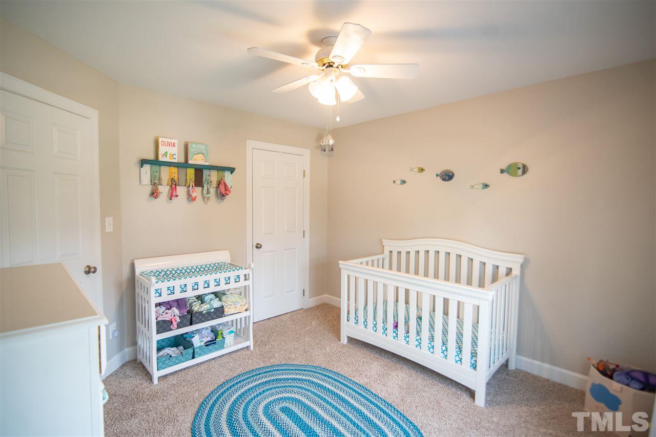 9116 Dawnshire Road Raleigh, NC 27615 - Photo 20 of 30 a bedroom with furniture and a chandelier fan