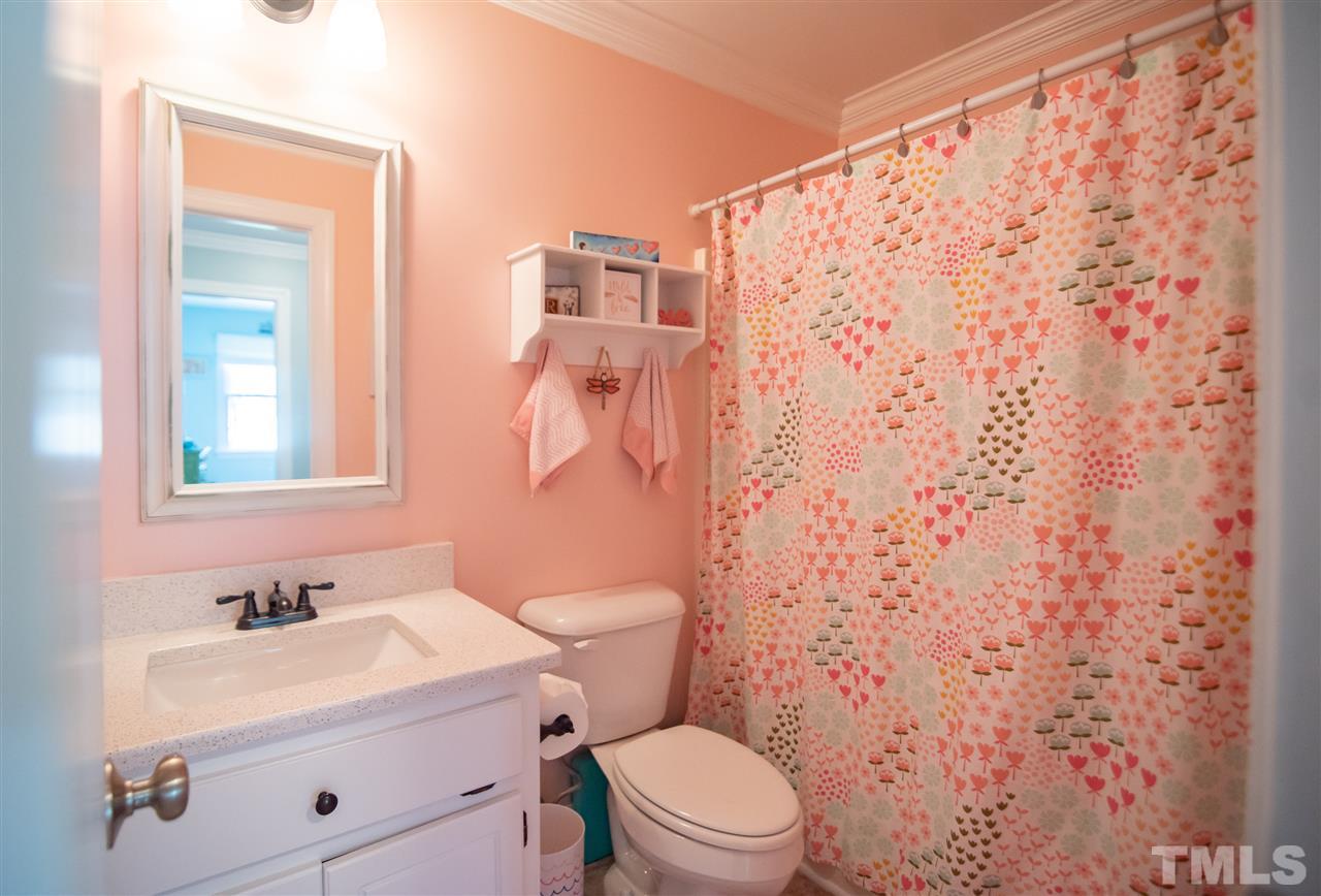 9116 Dawnshire Road Raleigh, NC 27615 - Photo 21 of 30 a bathroom with a sink a toilet and shower curtain