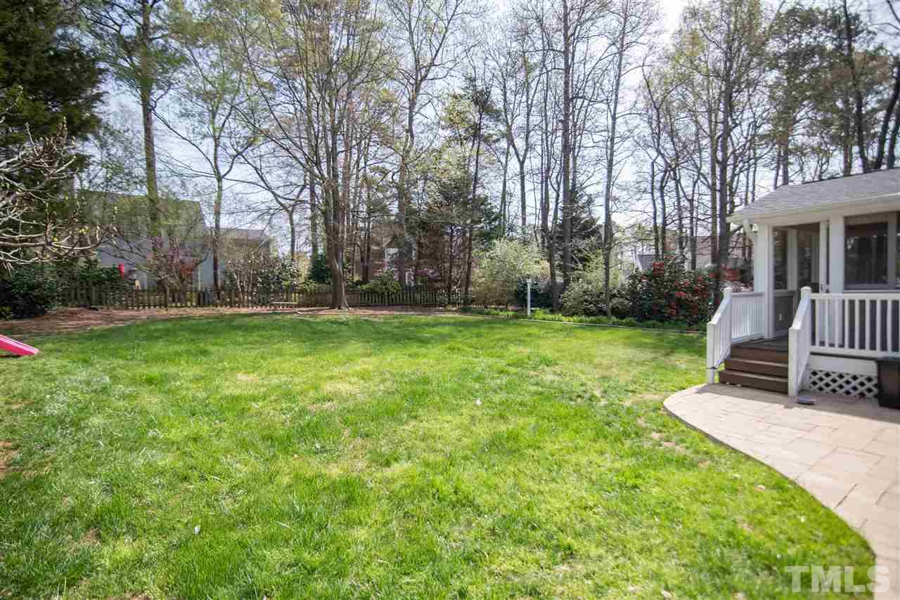 9116 Dawnshire Road Raleigh, NC 27615 - Photo 27 of 30 a view of a chair and table in backyard of house
