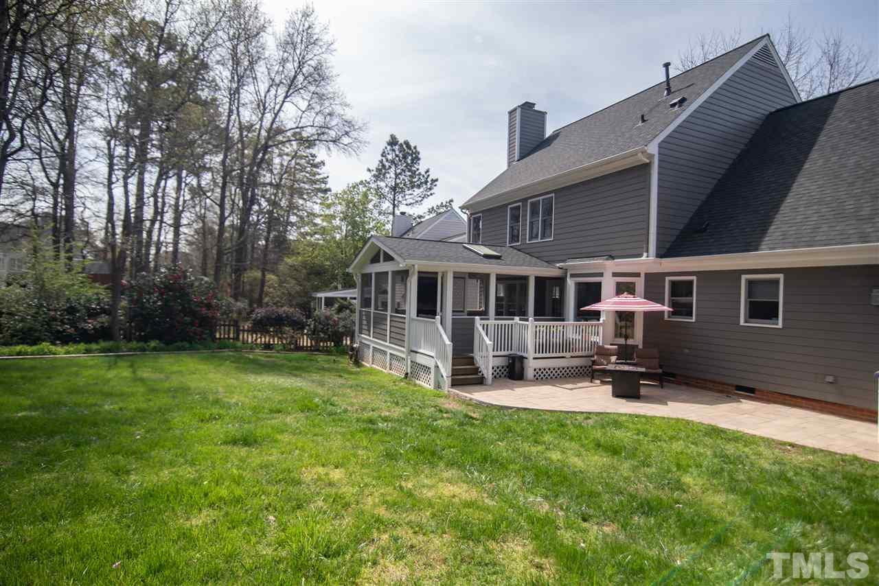 9116 Dawnshire Road Raleigh, NC 27615 - Photo 28 of 30 a front view of a house with a yard fire pit and outdoor seating