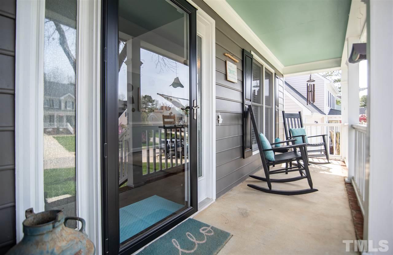 9116 Dawnshire Road Raleigh, NC 27615 - Photo 4 of 30 a view of a balcony with chair and floor to ceiling window