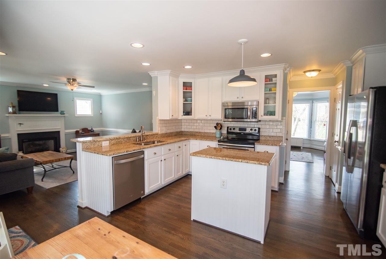 9116 Dawnshire Road Raleigh, NC 27615 - Photo 30 of 30 a kitchen with a sink appliances and wooden floor