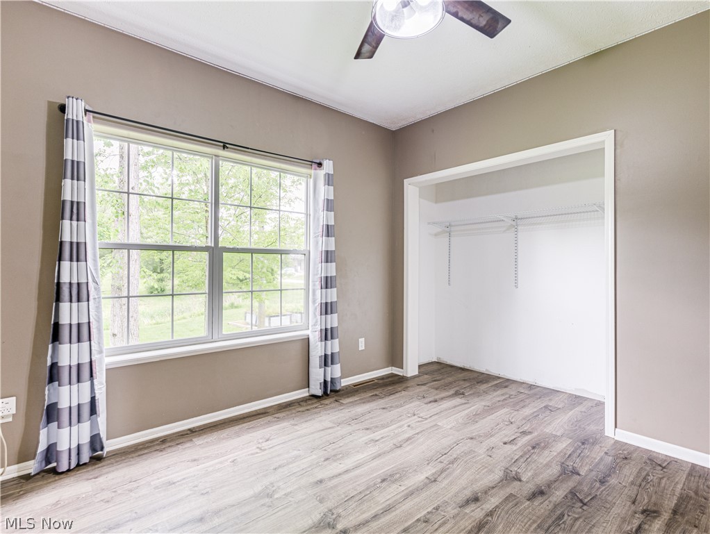 6573 Boneta Road Medina, OH 44256 - Photo 21 of 38 bedroom with a closet, ceiling fan, and light hardwood / wood-style flooring