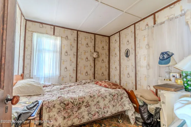 a bedroom with furniture and a window