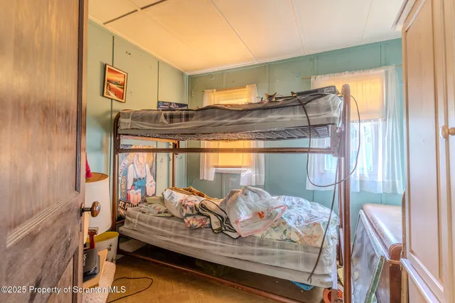 a living room with furniture a couch and two windows