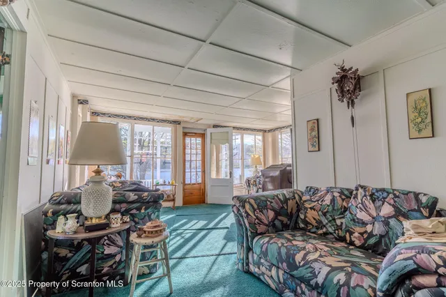 a living room with furniture and a floor to ceiling window