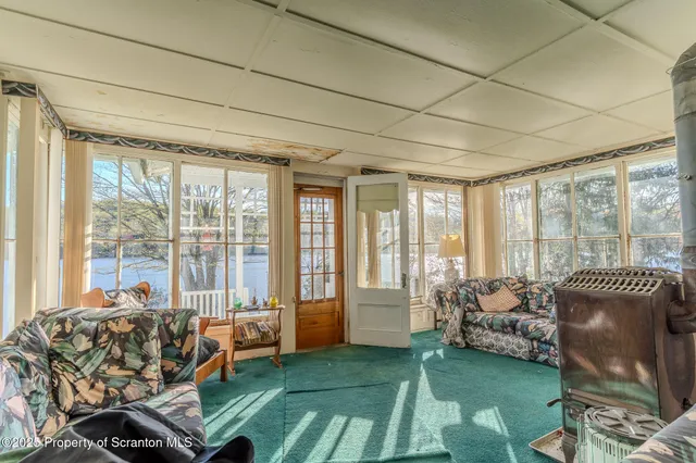 a living room with furniture and a floor to ceiling window
