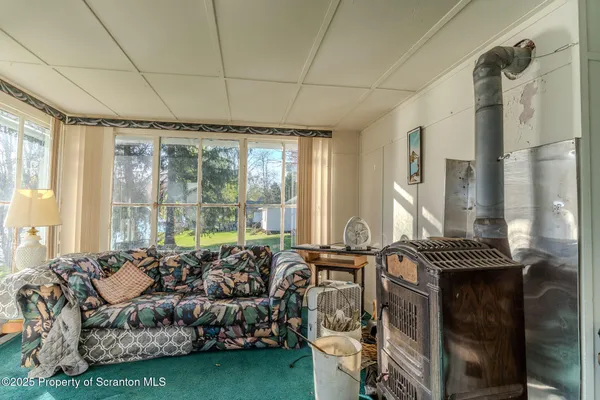 a living room with furniture and a floor to ceiling window